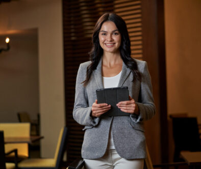 Lady in official clothing posing for photo with tablet