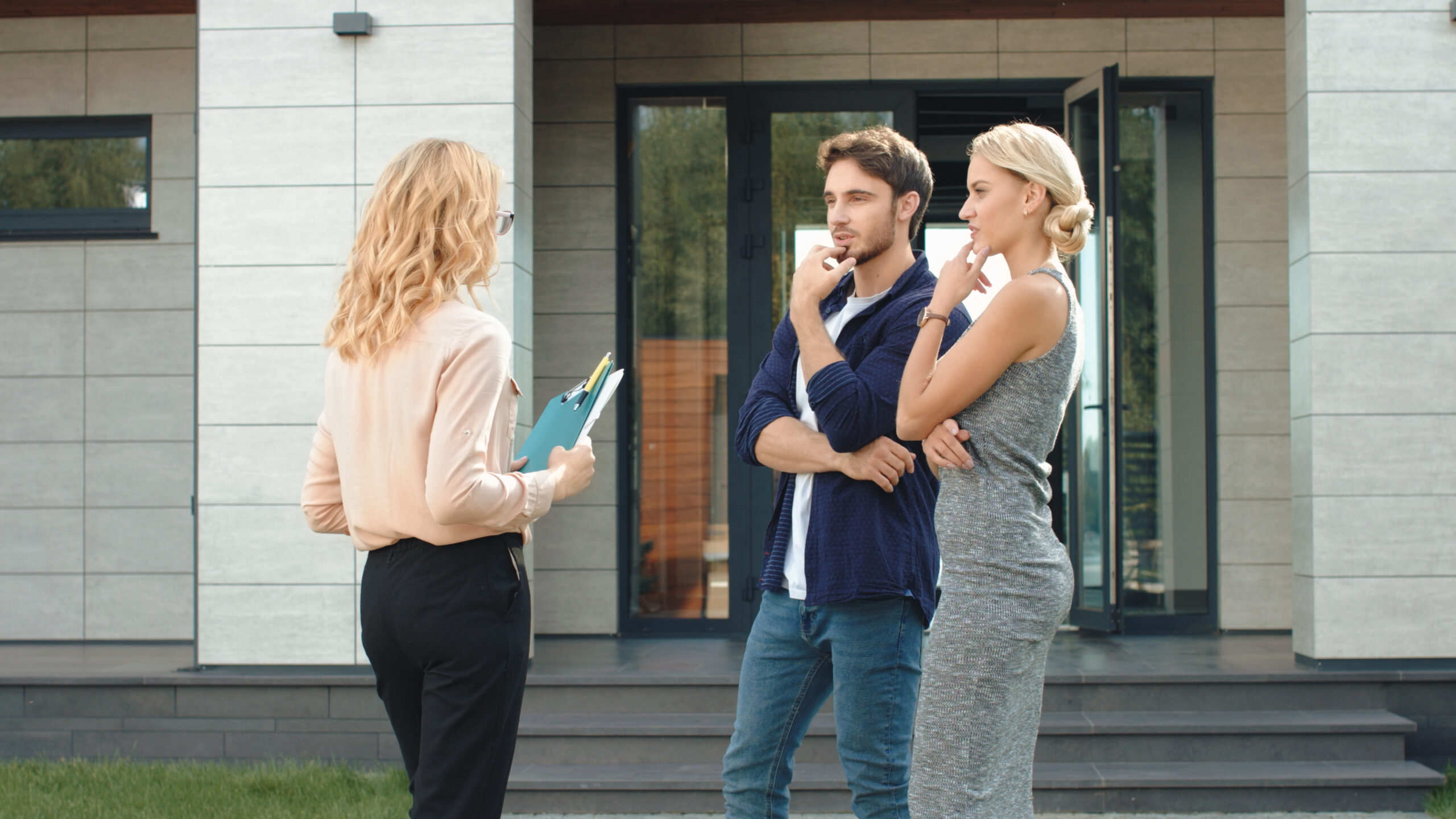 Business people staying near luxury house. Man and woman renting house together.